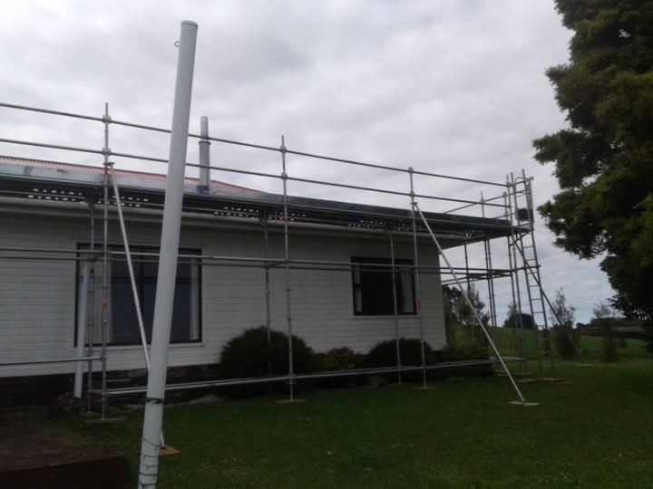 Scaffolding standing along the length of a new house at eaves height